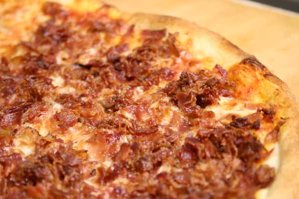 Pizza topped with cheese and bacon