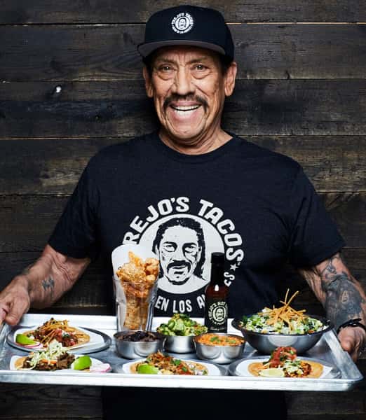 Danny Trejo Holding a plate of trejos tacos