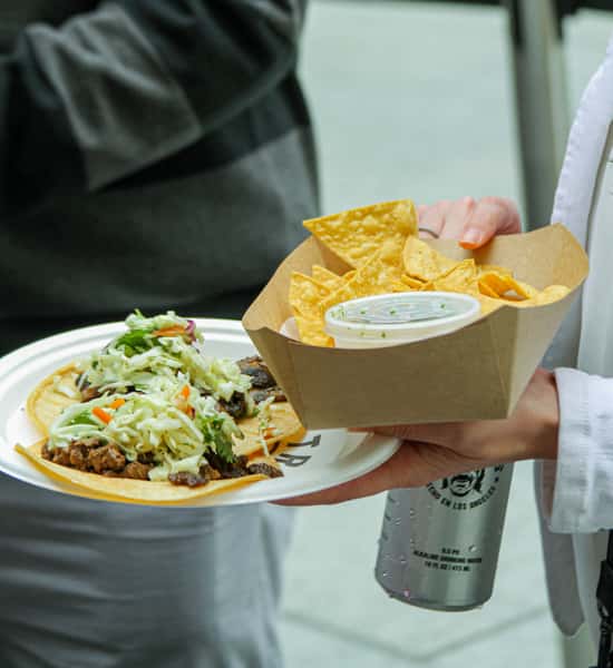 person-holding-chips-salsa-and-tacos