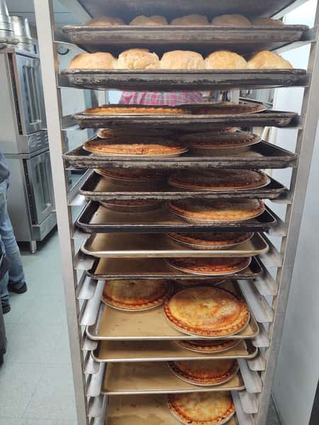 Racks of freshly baked pies and golden dinner rolls cooling in the kitchen of Crosswinds Restaurant in Payson, Arizona.