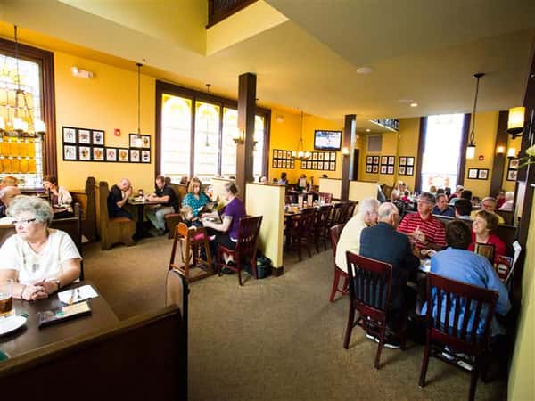 people sitting at tables inside restaurant