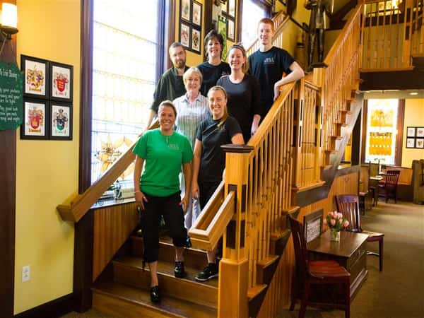 employees smiling for a picture on a staircase