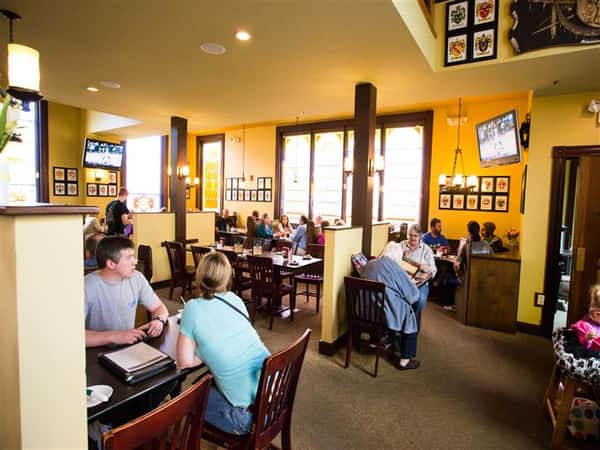 people sitting at tables inside restaurant