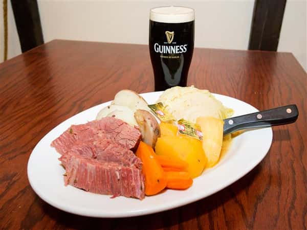 roast beef with carrots and potatoes with a glass of beer