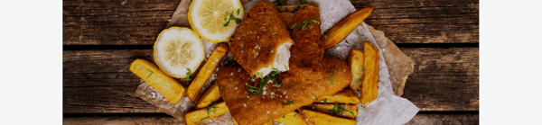 Crispy breaded fish fillet served with chips, lemon and fresh herbs.