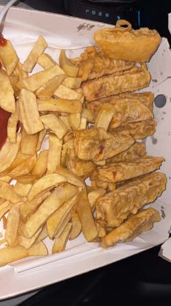 Chips topped with pieces of golden battered fish from Blue Bay in Bridgeton, Glasgow.