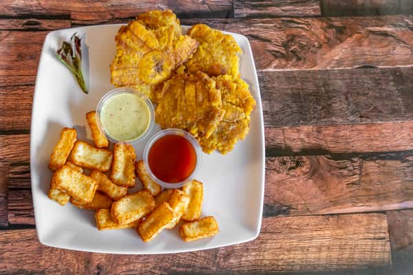 Crispy tostones and golden fried cheese served with garlic mayo and ketchup dip—popular Dominican side dish perfect for sharing.