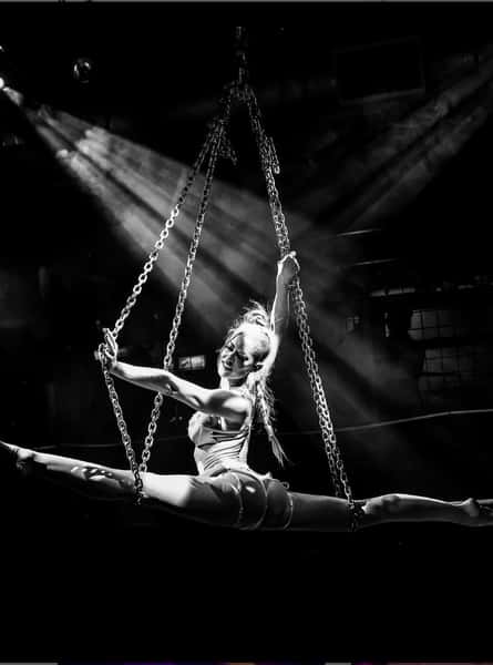 Viva La Glam performing splits on suspended aerial chains