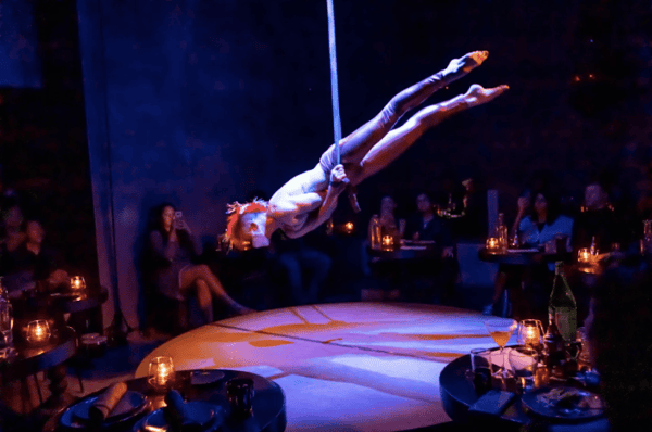 Strap aerialist performing on stage