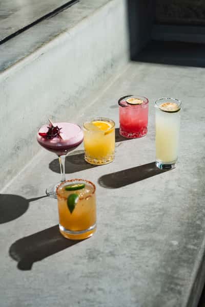 various glasses of cocktails and margaritas