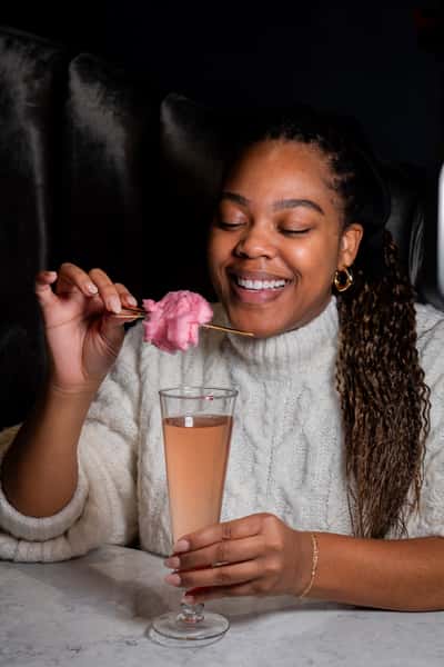 woman with pink cotton candy cocktail