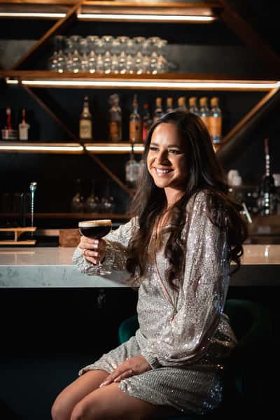 woman at bar with espresso martini