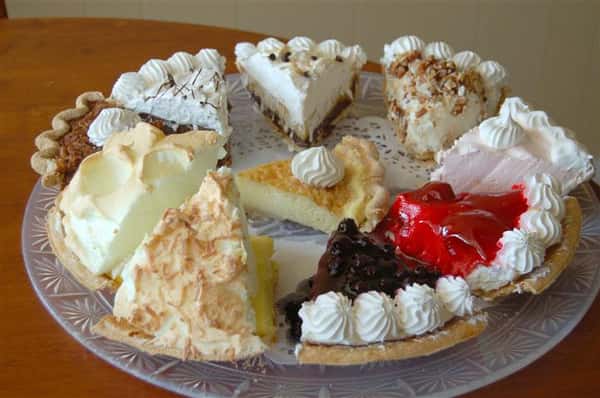 Plate with a variety of different pie and cake slices.