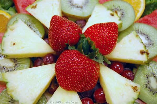 Close up of fruit platter with kiwi, strawberries and pineapple.