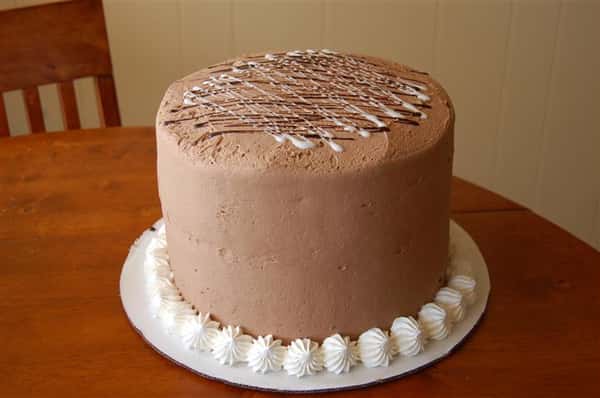 Tall cake with chocolate frosting.