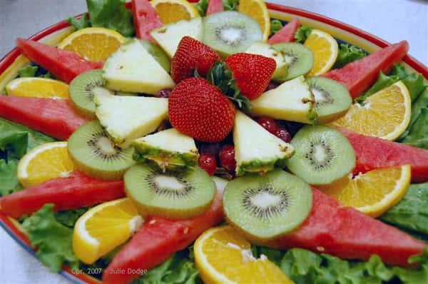 Fruit platter with oranges, watermelon, pineapple, kiwi and strawberries.