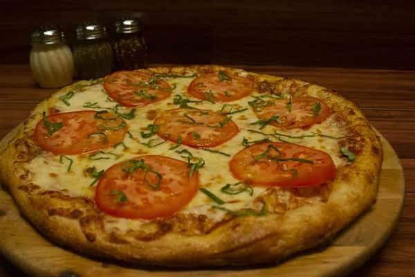 Caprese Pizza. Pizza topped with tomato sauce, mozzarella, sliced tomato, Italian sausage, black olives, oregano & virgin olive oil.