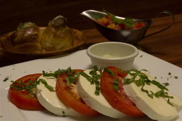 Caprese salad with basil. Garlic knots on the side.