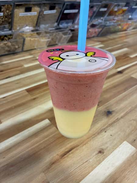 Layered strawberry and mango smoothie in a clear cup with lid and straw – refreshing tropical fruit smoothie perfect for a frozen yogurt shop or juice bar menu.