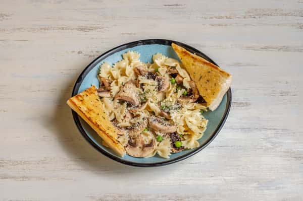 Bowtie pasta, wild mushrooms, sweet peas and fresh basil in a herb-infused olive oil