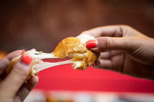 a mac and cheese ball being pulled appart
