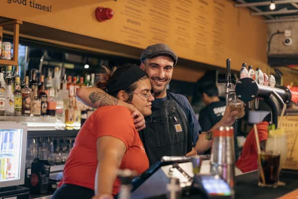 bartender and bartender hugging