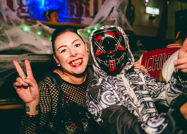 two people in halloween costumes posing