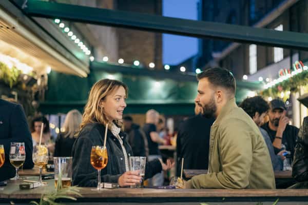 boy and girl conversing over drinks
