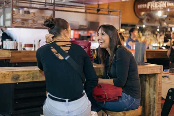 two girls laughing on table