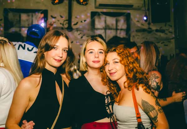 three girls smiling at camera