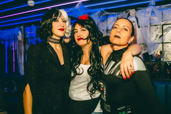 3 girls posing at camera in halloween costumes