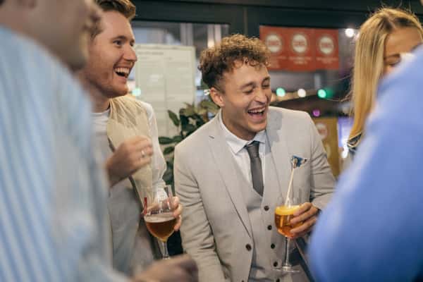 men laughing with drinks