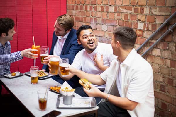 boys laughing over food and drinks
