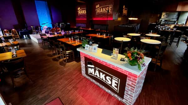 Event-ready restaurant venue with welcome station, banquet seating, and upscale private party setup
