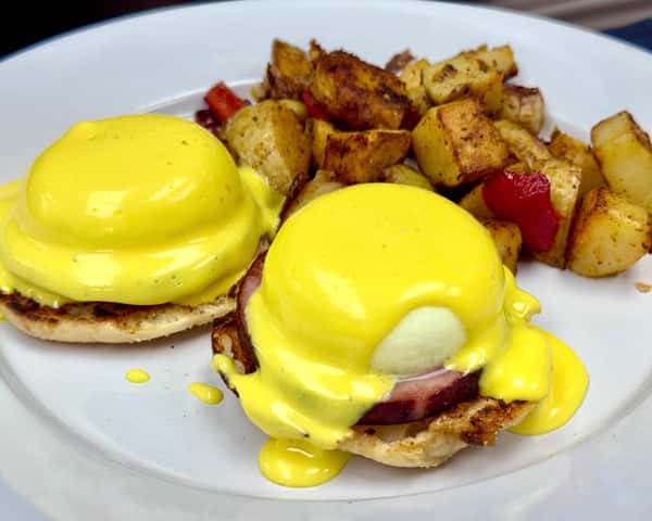 Eggs Benedict with Canadian bacon, hollandaise sauce, and crispy breakfast potatoes