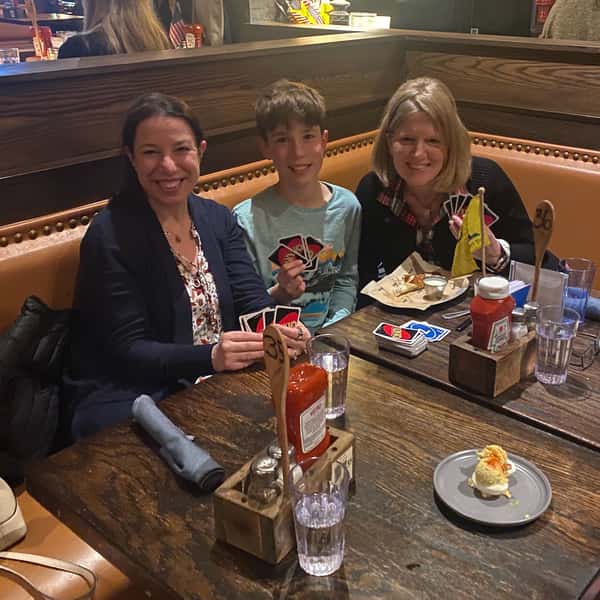 2 women and boy playing Uno