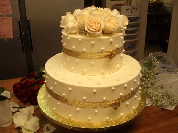 two tiered cake with ribbon