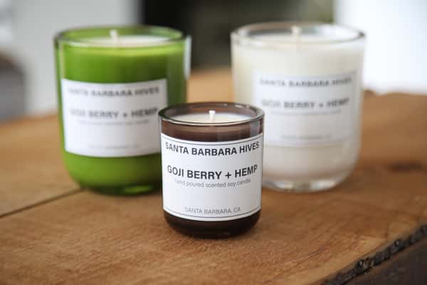 Three soy candles from Santa Barbara Hives in green, white, and amber glass jars.