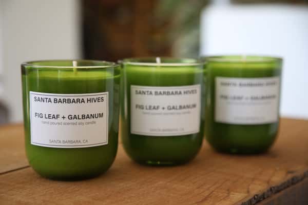 Three green "Fig Leaf + Galbanum" scented candles from Santa Barbara Hives