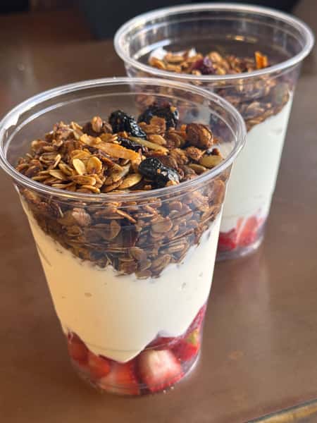 Parfait cups with granola, yogurt, and strawberries