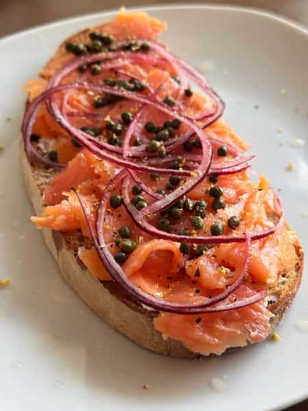 Open-faced smoked salmon toast with red onions and capers