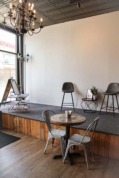 AJ's Riverside restaurant rustic interior with seating area and stage.