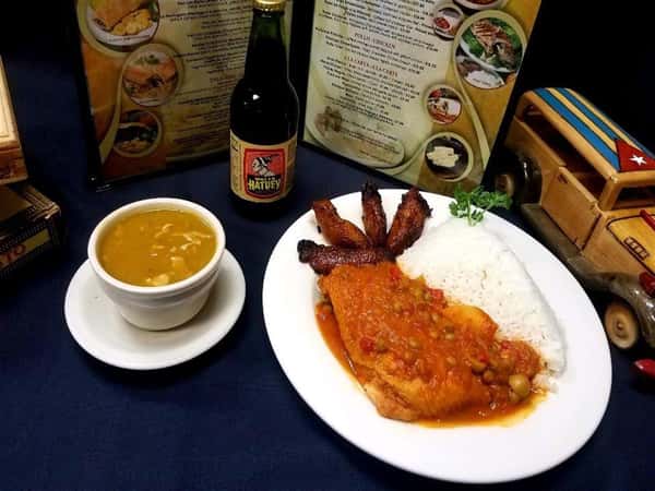 Filete de Pargo a la Plancha. Grilled red snapper filet topped with salsa criolla (creole sauce). white rice, fried plantains and cup of soup on the side.