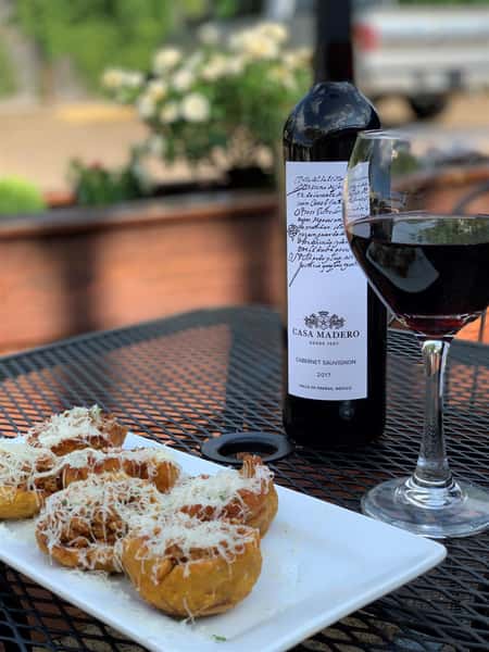 menu item outside on a table with red wine