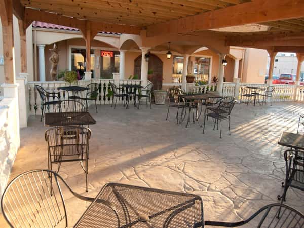 Outdoor patio. Black metal tables and chairs.