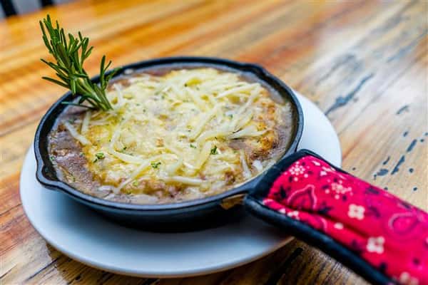 soup in a skillet topped with cheese