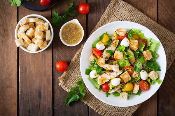 salad topped with egg, croutons and tomatoes