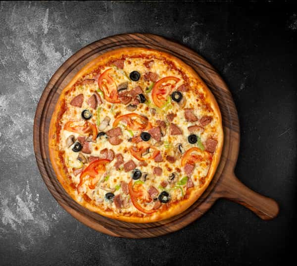 Cheezy Pizza's rustic-style pizza with tuna, olives, and tomatoes sits on a wooden board.