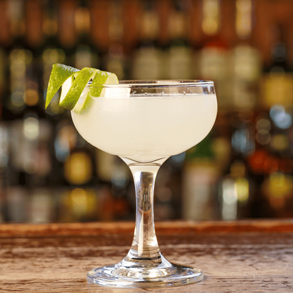 Classic lemon drop martini in a chilled stemmed glass on a polished wooden bar at Pourhouse Bar & Grill in Loveland.