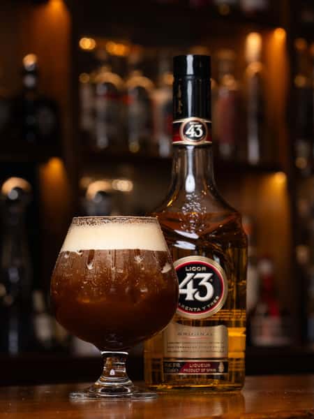 Licor 43 espresso-style cocktail served in a stemmed glass beside premium Spanish liqueur bottle at a modern Mexican bar